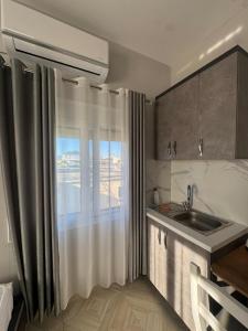 a kitchen with a sink and a window at Vila Zini in Vlorë +49 photos