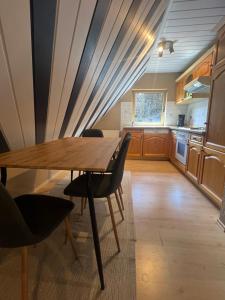 a kitchen with a wooden table and chairs at Ferienwohnung Blumenthal bei Kiel in Blumenthal +13 photos