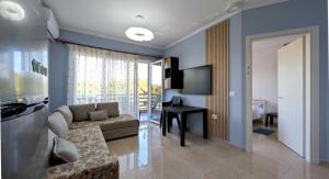 a living room with a couch and a table at Sophi's Dream Apartment in Lalzit Bay