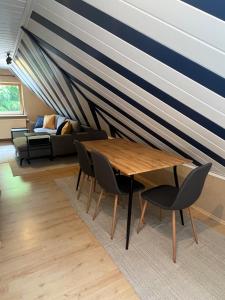 a room with a table and chairs and a couch at Ferienwohnung Blumenthal bei Kiel in Blumenthal
