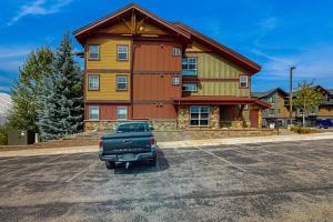 a truck parked in a parking lot in front of a building at First Tracks 4202 in Steamboat Springs