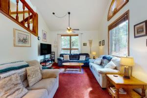 a living room with a couch and a table at Whispering Pines 323 in Durango