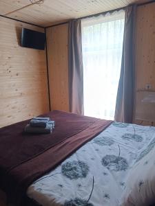 a bed in a room with a window at evkalipt in Ivano-Frankivsk