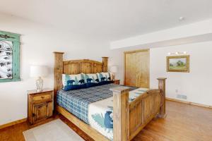 a bedroom with a wooden bed with a wooden headboard at Rio Grande Lodge in South Fork