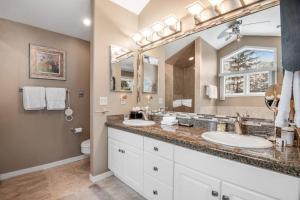 a bathroom with two sinks and a large mirror at The Gem of Vail in Vail +83 photos
