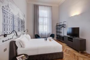 a hotel room with a bed and a television at San Carlo Suite Torino in Turin