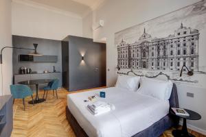 a hotel room with a large bed and a table at San Carlo Suite Torino in Turin