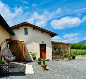 a house with a swing in front of it at Le Boudoir, inclus petit déjeuner in Quincié-en-Beaujolais