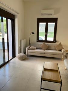 a living room with a couch and a table at CasaKOS in Kos