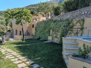 a house with a yard with a tree and a tub at La Cornice dei Monti in Tramonti +56 photos