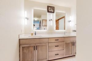 a bathroom with a sink and a mirror at Frisco Home Base in Frisco