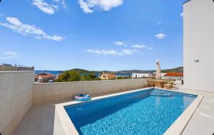 a swimming pool on the roof of a house at Elia apartments in Ražanj