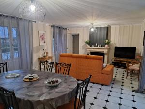 a living room with a table and a couch at Gîte Lebasladin in Lison