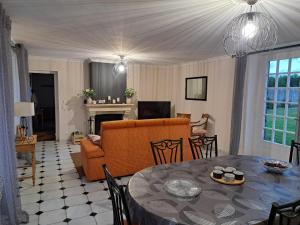 a living room with a table and a couch at Gîte Lebasladin in Lison
