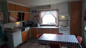 a small kitchen with a table and a window at Grodås Lake View Apartment in Hornindal