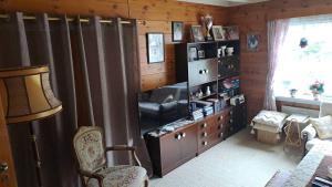 a living room with a couch and a television at Grodås Lake View Apartment in Hornindal