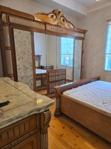 a bedroom with a large bed and a mirror at Bilgah Garden Villa in Bilgah +26 photos