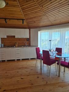 a kitchen and dining room with a table and chairs at Bilgah Garden Villa in Bilgah