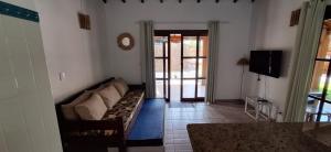 a living room with a couch and a tv at Quinta do Sahy in São Sebastião