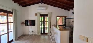 a kitchen with white walls and wooden ceilings at Quinta do Sahy in São Sebastião