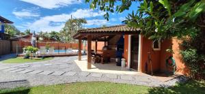 a patio with a pavilion next to a house at Quinta do Sahy in São Sebastião
