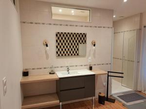 a bathroom with a sink and a shower at Gîte Lebasladin in Lison +18 photos