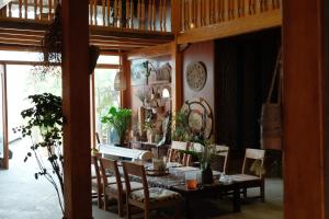 a dining room with a table and chairs at Hihi Homestay Tả Van - Mountain View & Local Experience in Sa Pa in Tả Van