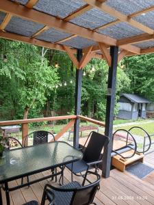 a patio with a table and chairs on a wooden deck at evkalipt in Ivano-Frankivsk
