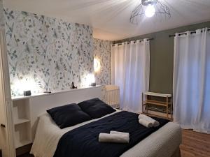 a bedroom with a bed with two towels on it at Gîte Lebasladin in Lison