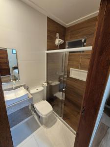 a bathroom with a toilet and a sink and a shower at NOVO HOTEL in Conceição do Coité +44 photos