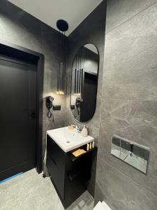 a bathroom with a sink and a mirror at Willa Czarny Puzzel in Tarnowska Wola +18 photos