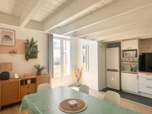 a living room with a table and a kitchen at Large 2 bedrooms Duplex - City Center & free Parking in Arcachon