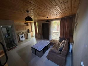 a living room with a couch and a table at Levani's Cottage in Borjomi
