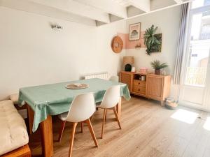 a dining room with a table and two chairs at Large 2 bedrooms Duplex - City Center & free Parking in Arcachon +20 photos