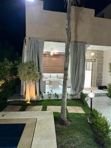 a living room with a couch and a table at villa privée ghmat in Marrakesh