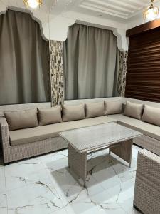 a living room with a couch and a table at villa privée ghmat in Marrakesh