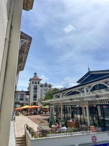 a building with tables and chairs in a city at Large 2 bedrooms Duplex - City Center & free Parking in Arcachon