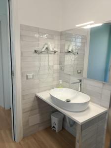 a bathroom with a white sink and a mirror at White Beach in Alghero +55 photos