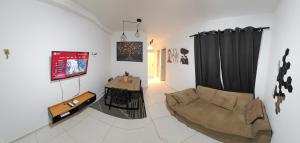 a living room with a couch and a table at Apartamento completo no Bérgamo in Feira de Santana