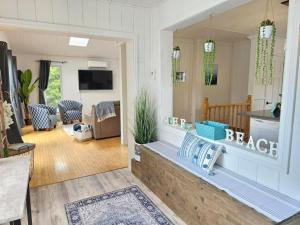 a living room with a large mirror on the wall at Chalet Cozy Spa sur Lac in Saint-André-Avellin