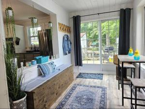 a living room with a large window and a table at Chalet Cozy Spa sur Lac in Saint-André-Avellin