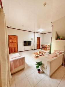 a large living room with a couch and a table at Casa Clara La Union in Dalumpinas Oeste