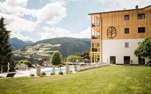a view of a building with a yard and a pool at Hotel Nussbaumerhof *** in Rodengo