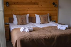 two towels are sitting on top of a bed at Князів Двір in Bukovel +113 photos