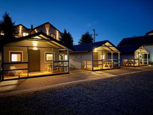 a row of houses at night with the lights on at Willa Alexandria - Basen, Cisza, Komfort - Domki i Apartamenty Karwia in Karwia