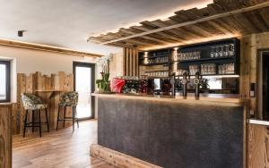 a bar in a room with wooden walls and wooden floors at Hotel Nussbaumerhof *** in Rodengo