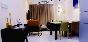 a dining room with a black table and green chairs at Greenland HomeINN in Kigali