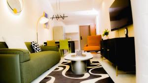 a living room with green furniture and a table at Greenland HomeINN in Kigali