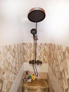 a shower in a bathroom with a sink at Cozy South in Mahébourg +26 photos