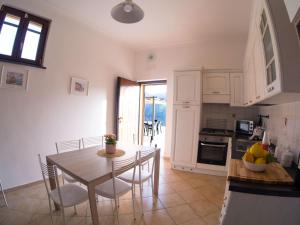 a kitchen and dining room with a table and chairs at La Cornice dei Monti in Tramonti